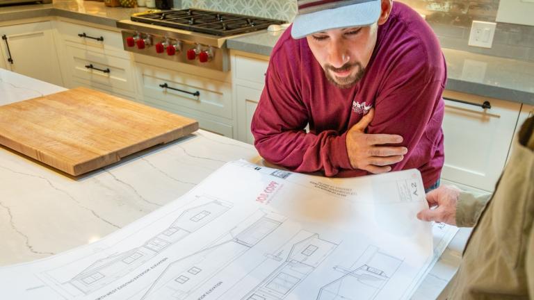 Man reading blue prints