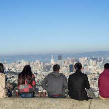 Four people sitting and looking at San Francisco skyline