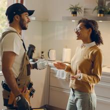 Contractor and homeowner talking in the kitchen.